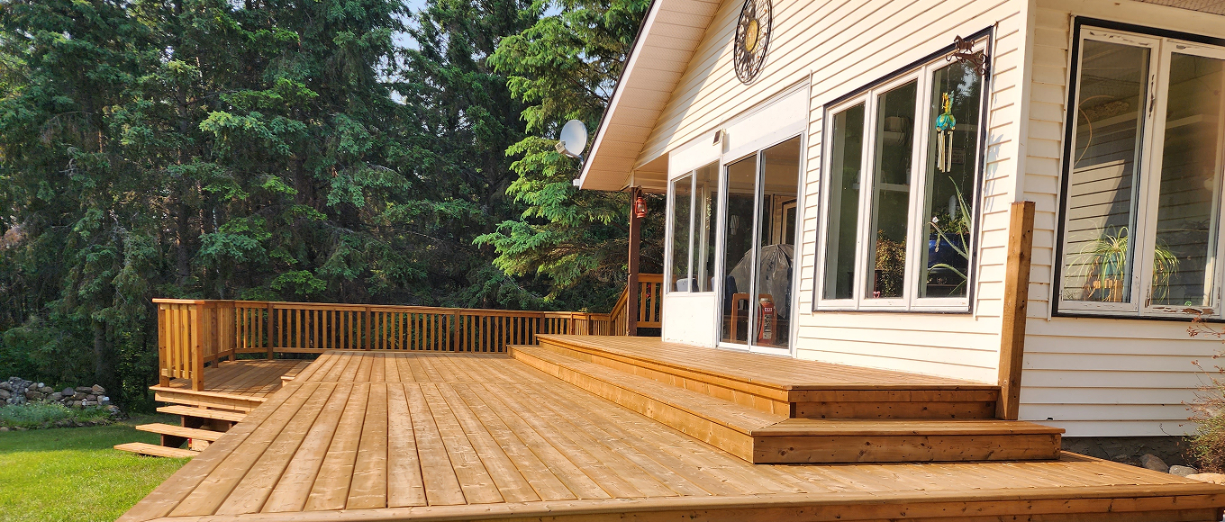 Freshly stained cedar deck and exterior of a home in Chestermere, Alberta — The Birds Stain