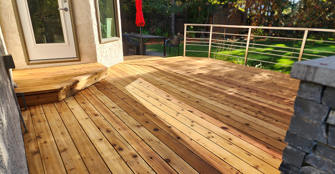 Freshly stained cedar deck with built-in bench in Chestermere, Alberta